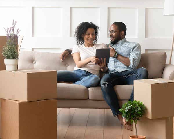 Happy Couple Relaxing On The Sofa In There New Home