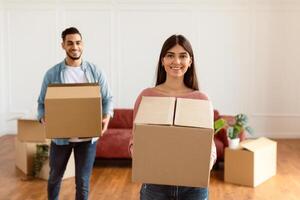 Happy Couple In There new home holding boxes