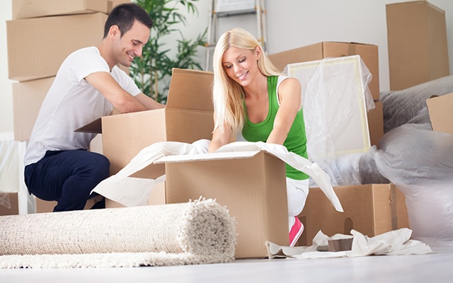 A Happy couple opening there boxes in the new home