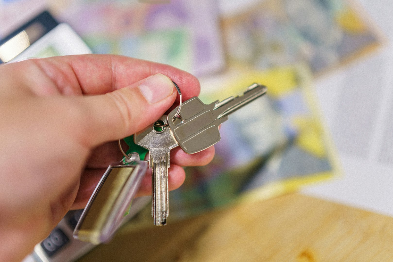 A man holding keys to a property