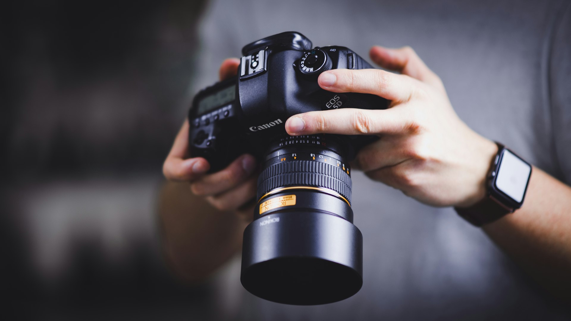 A Man holding a camera looking at the images