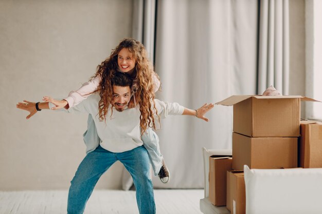 a mancarrying his wife on his shoulders in there new home